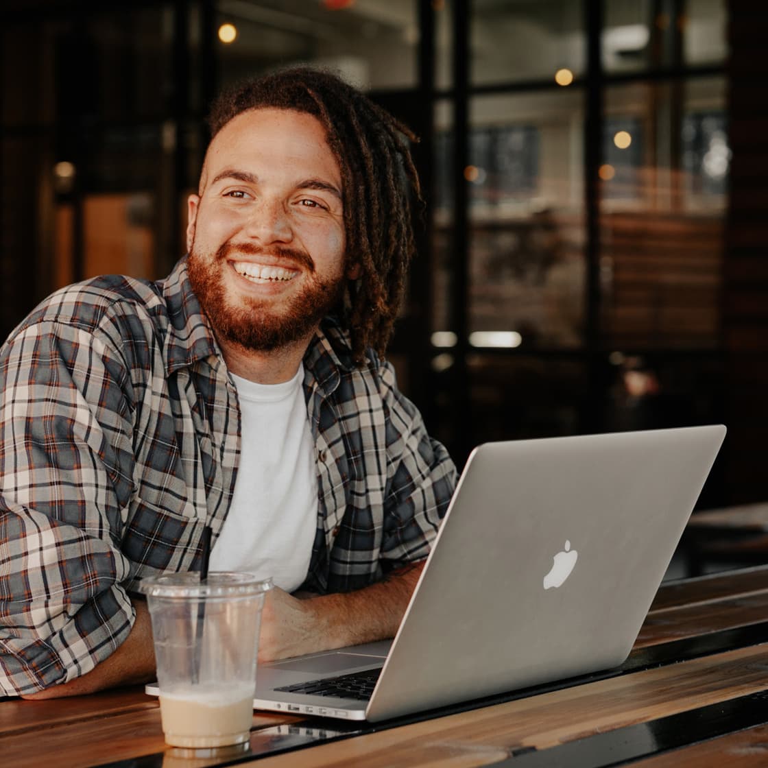 Smiling business owner working on a laptop