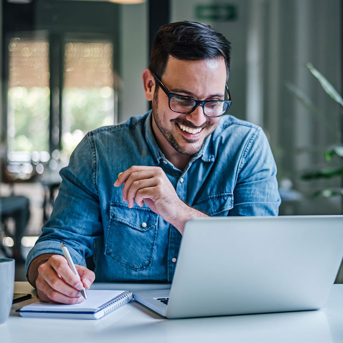 Man comparing broadband prices on laptop