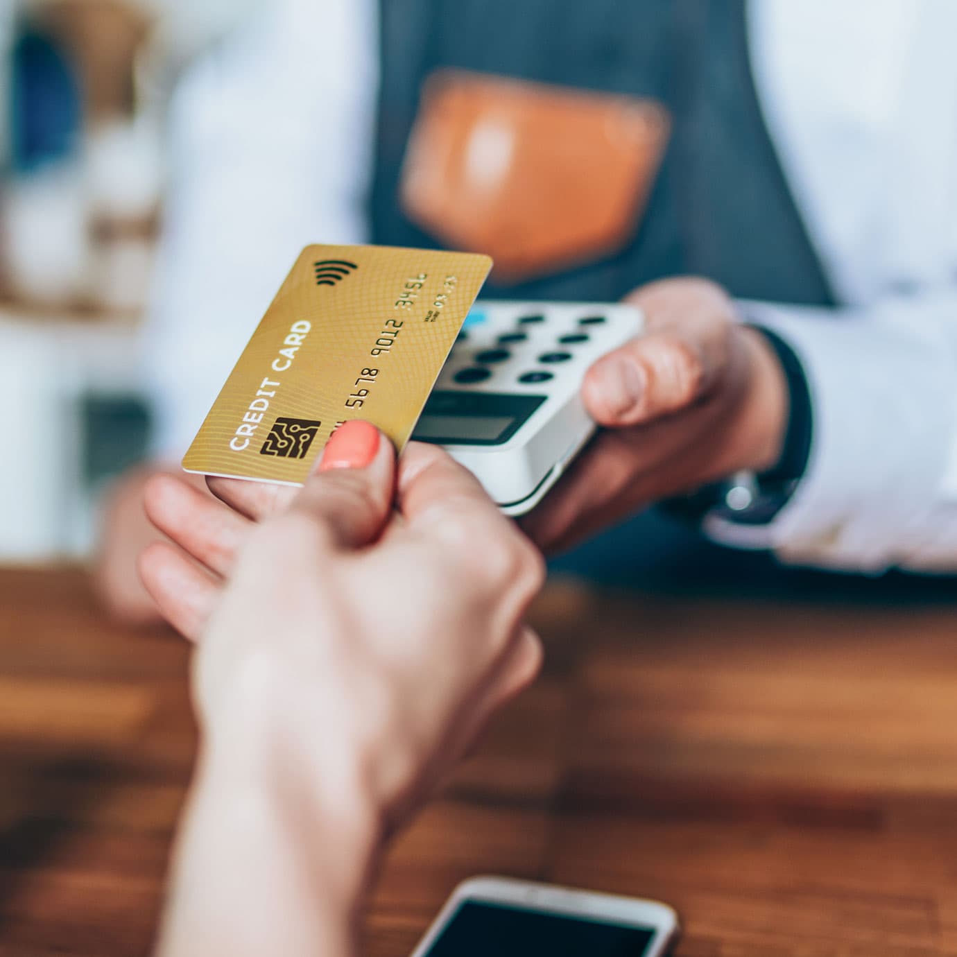 Woman paying with credit card and card reader